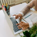 pexels-photo-5467594 Person in Brown Blazer Using Laptop